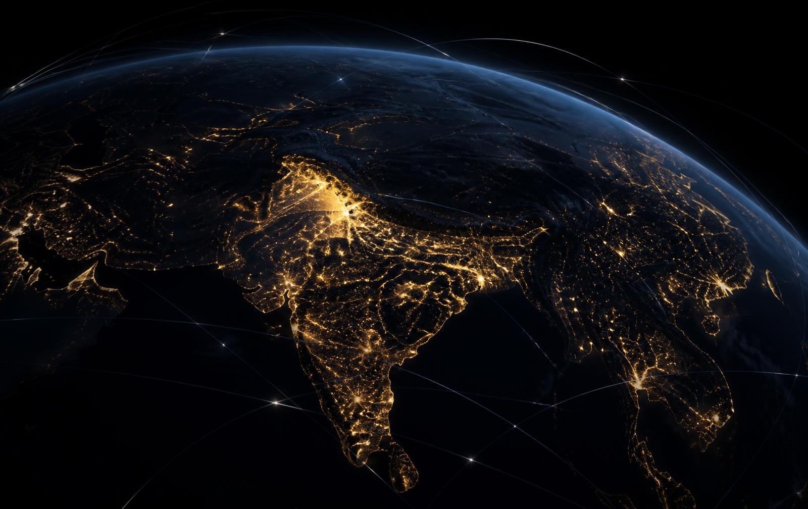 Night view of Earth from orbit showing city lights across South Asia